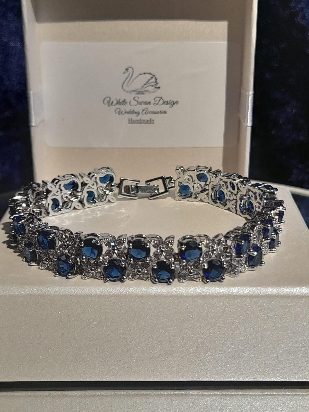 Silver bracelet with blue stones on a branded box