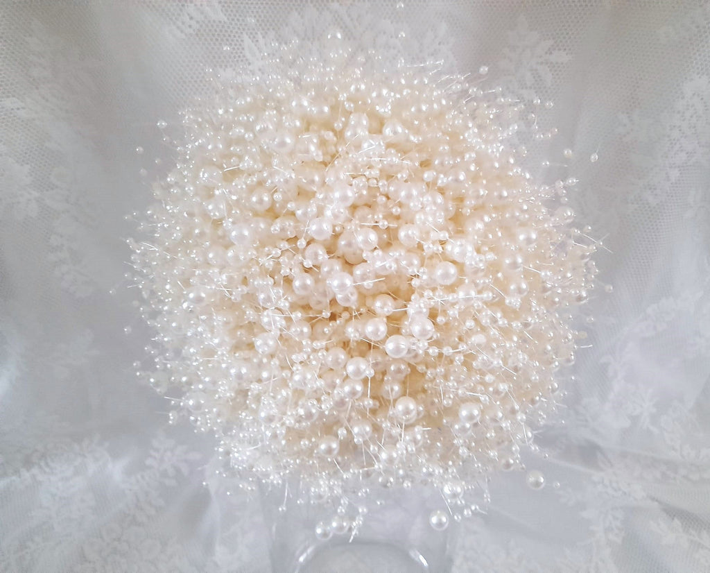Ivory pearlbouquet on a white fabric background