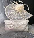 Ivory fascinator and clutch bag with decorative elements on a gray fabric background