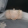 Champagne embroidered clutch bag with gold crystal chain on a black background