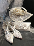 White wedding shoes, headpiece, and clutch on a dark background