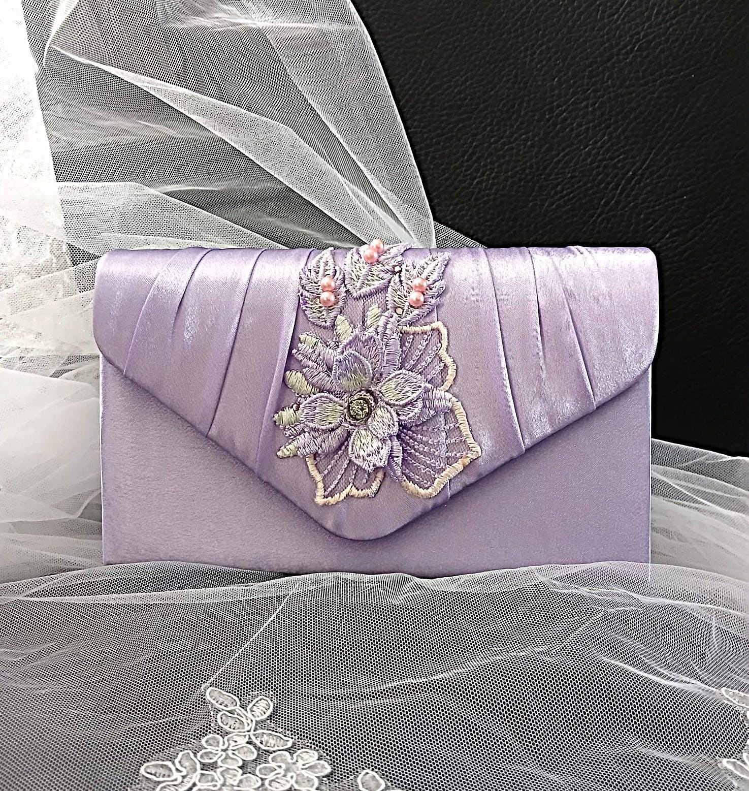 Lavender clutch with floral embroidery on a sheer fabric background