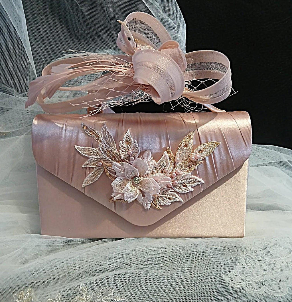 Pink handbag and matching fascinator with floral designand  on a tulle background