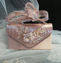Pink handbag and matching fascinator with floral designand  on a tulle background