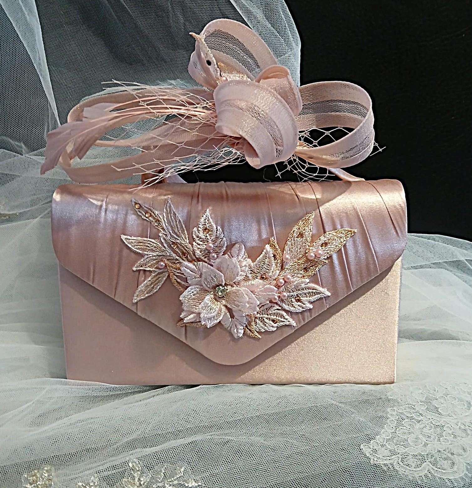 Pink handbag and matching fascinator with floral designand  on a tulle background