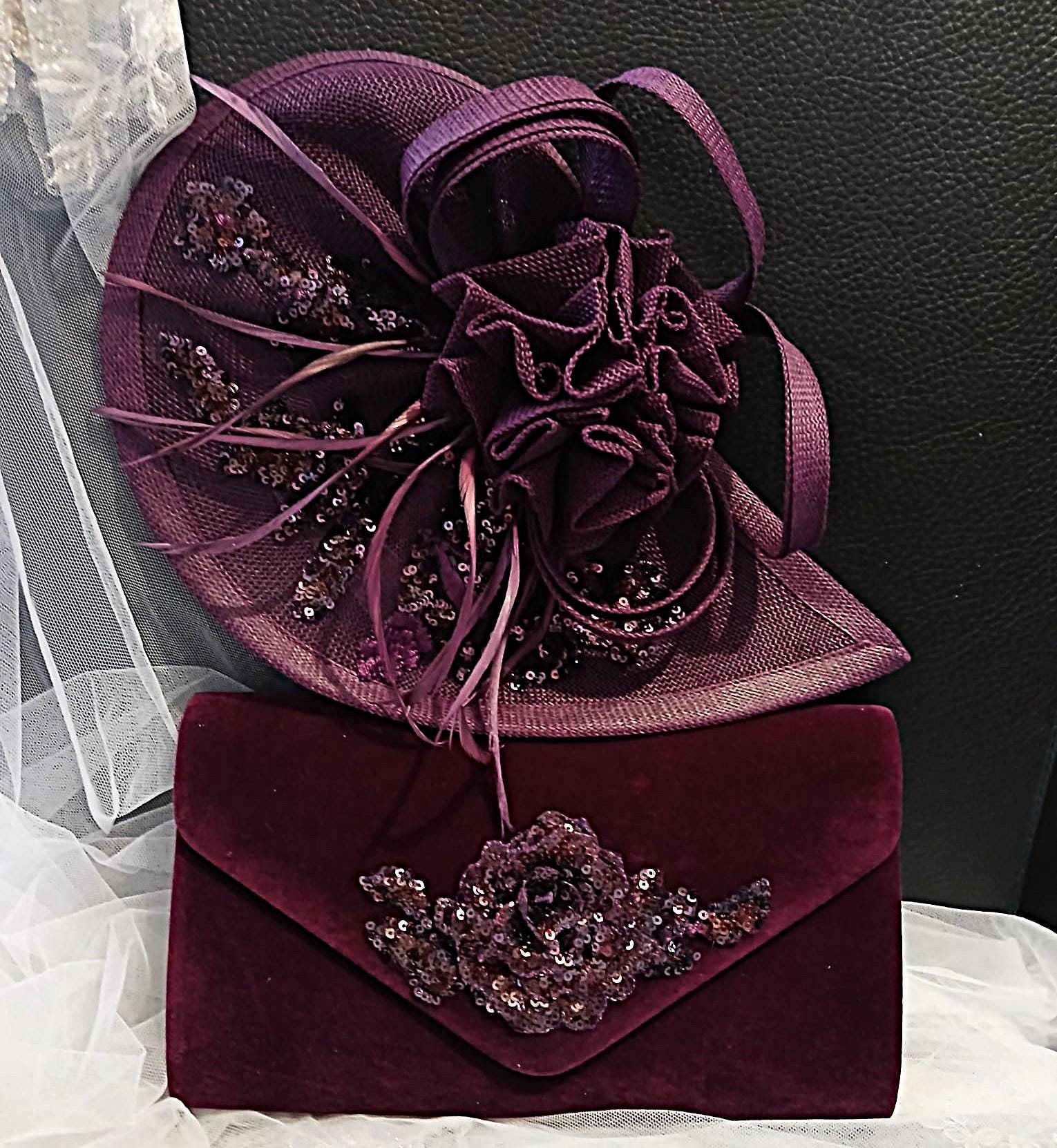 Purple fascinator and matching clutch bag with floral embellishments on a white and black background.