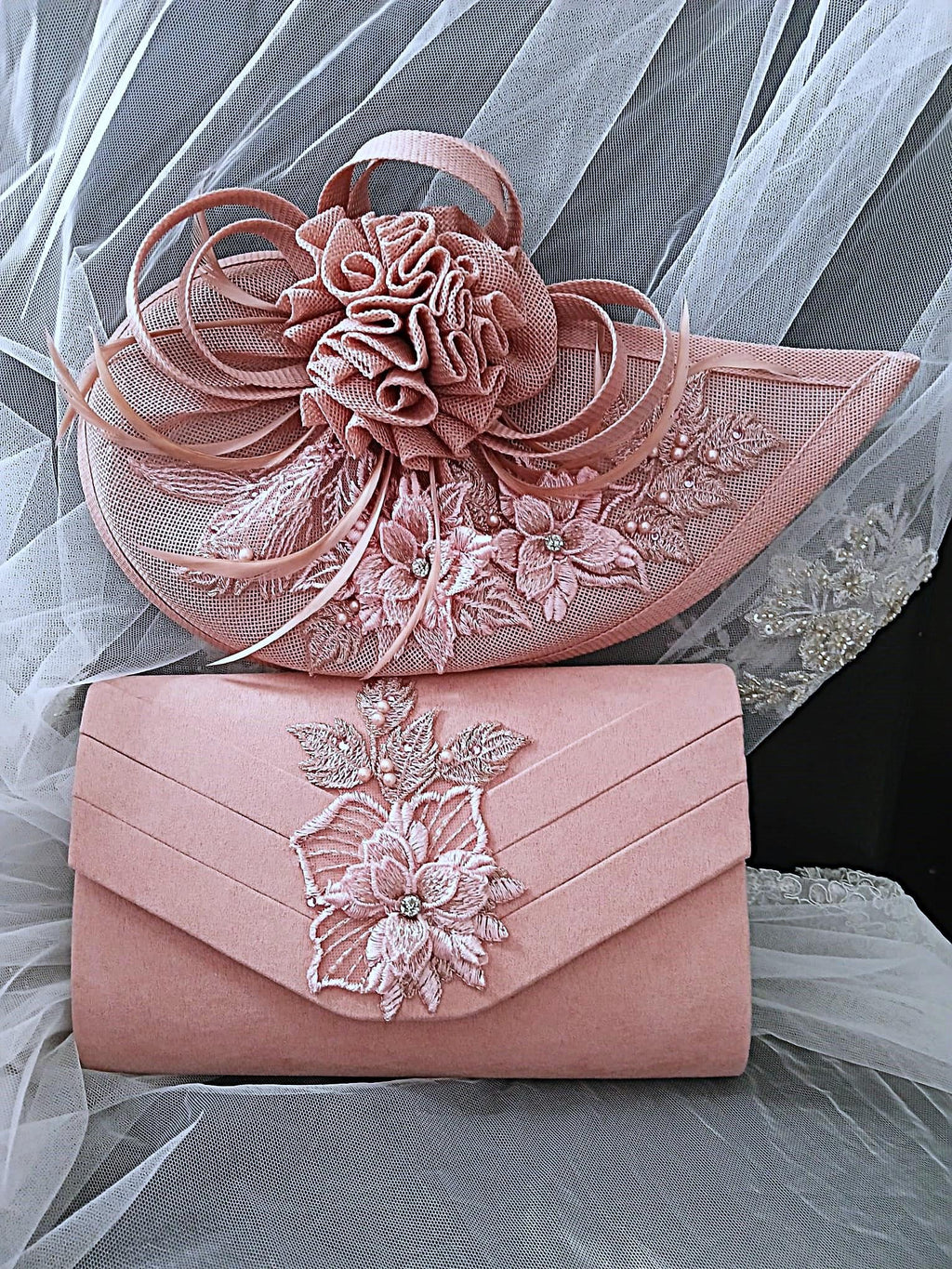 Pink handbag and hat with floral embroidery on a sheer fabric background