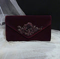 Deep Purple velvet clutch with sequin embellishment on a white fabric background