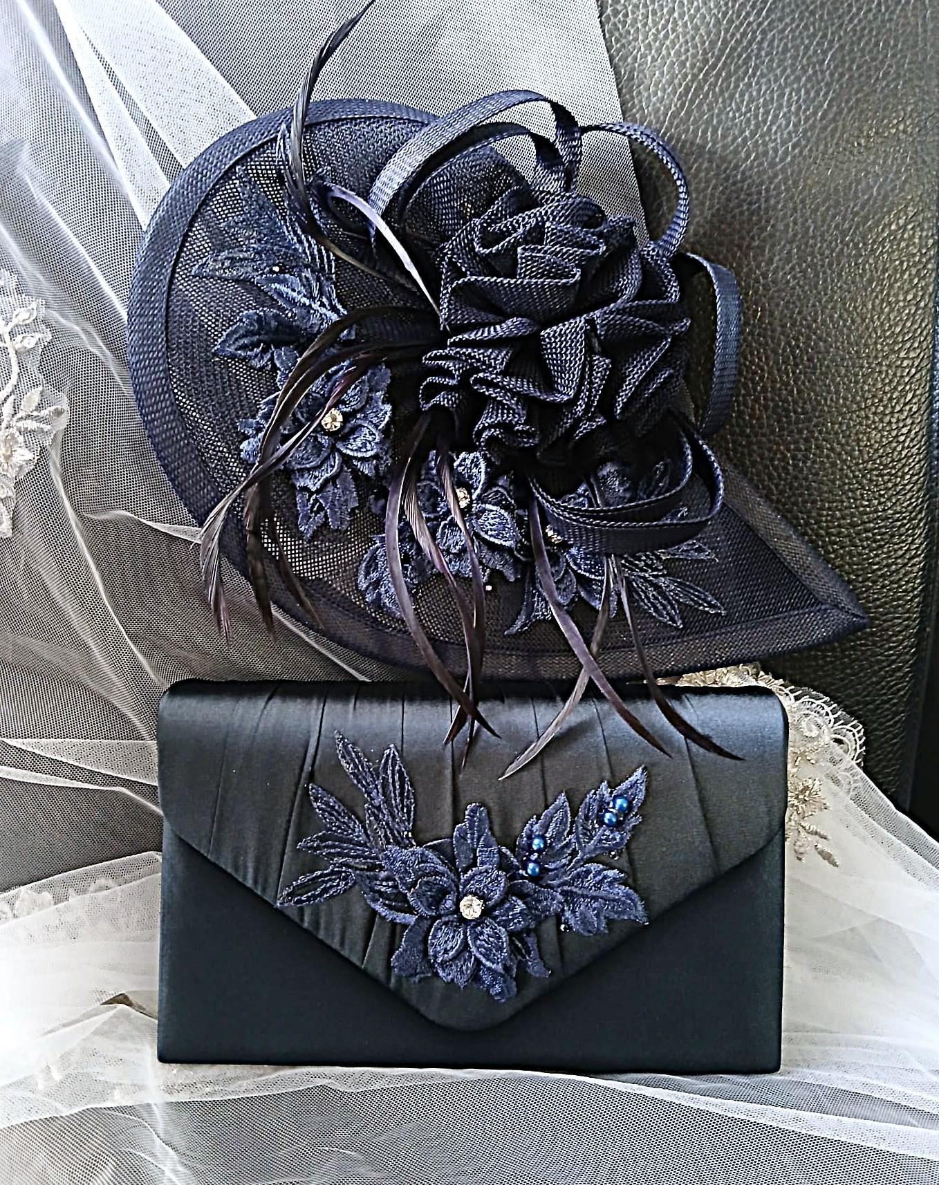 Navy Blue embroidered hat and clutch bag on a white lace background